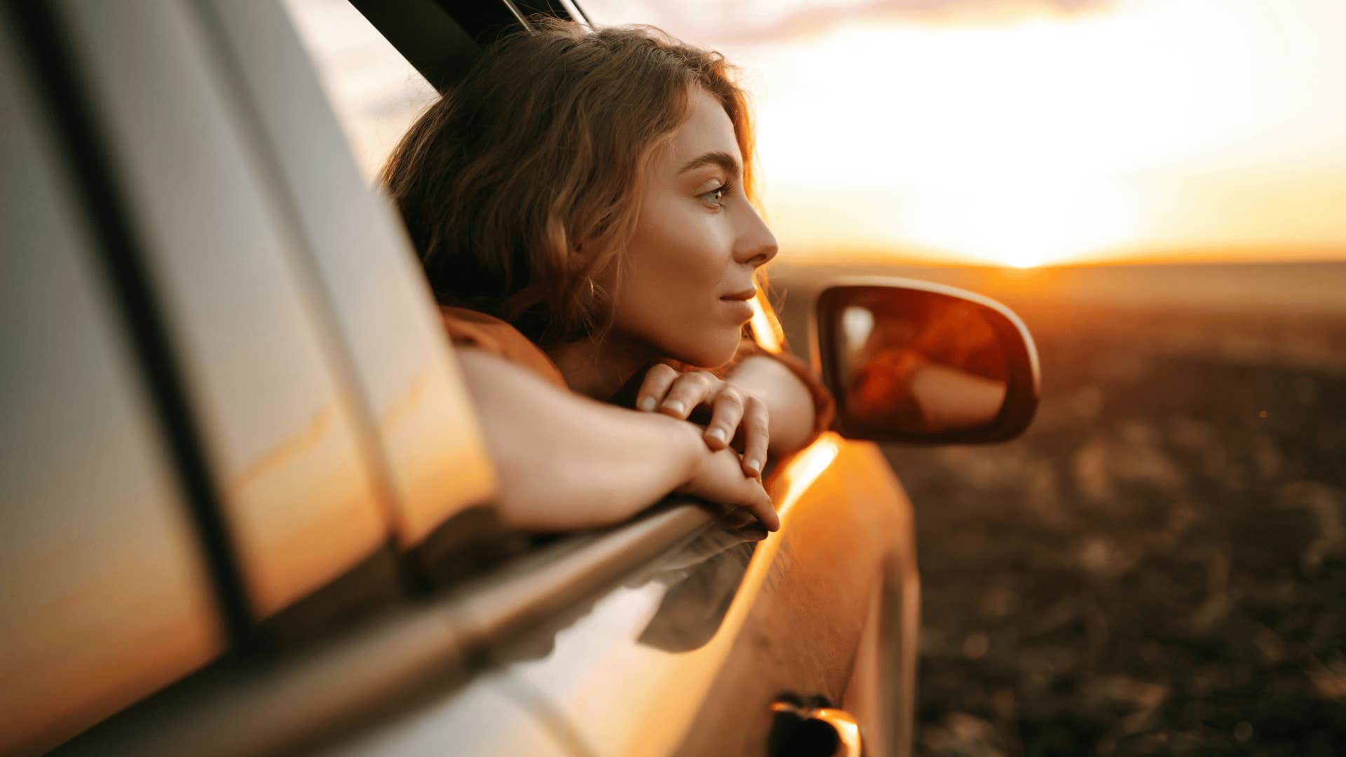 woman trying to live her life authentically through car window