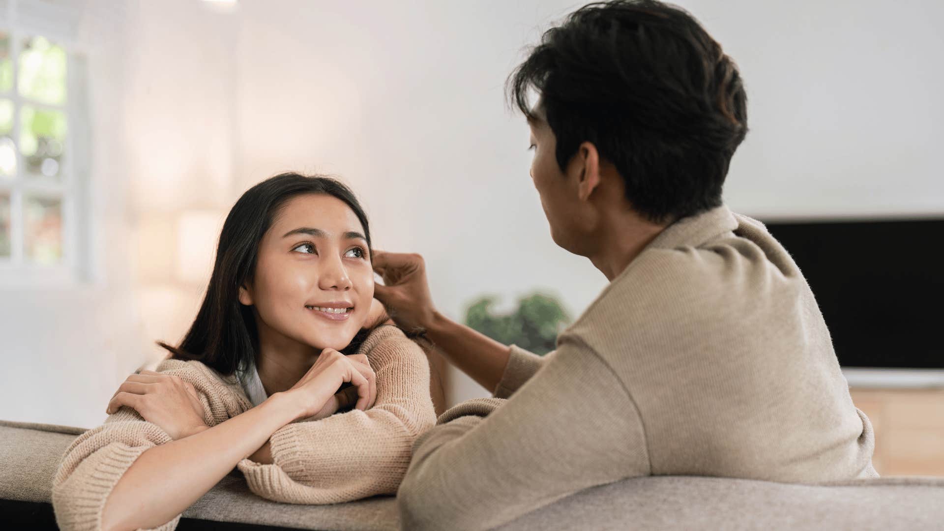 woman hiding her true feelings from her partner