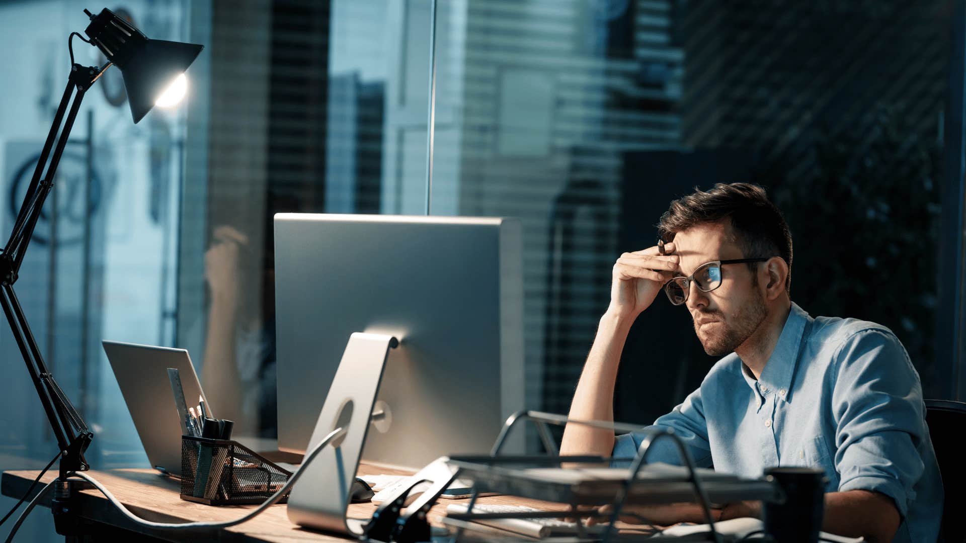 man overworking himself late at night