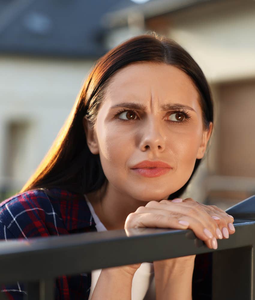 Nosey person leans over fence showing they are following ex after divorce