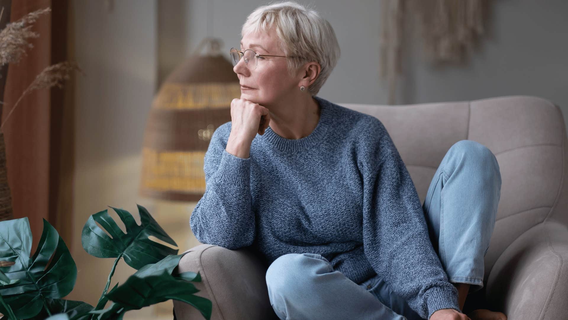 Grandmother reflecting while sitting down
