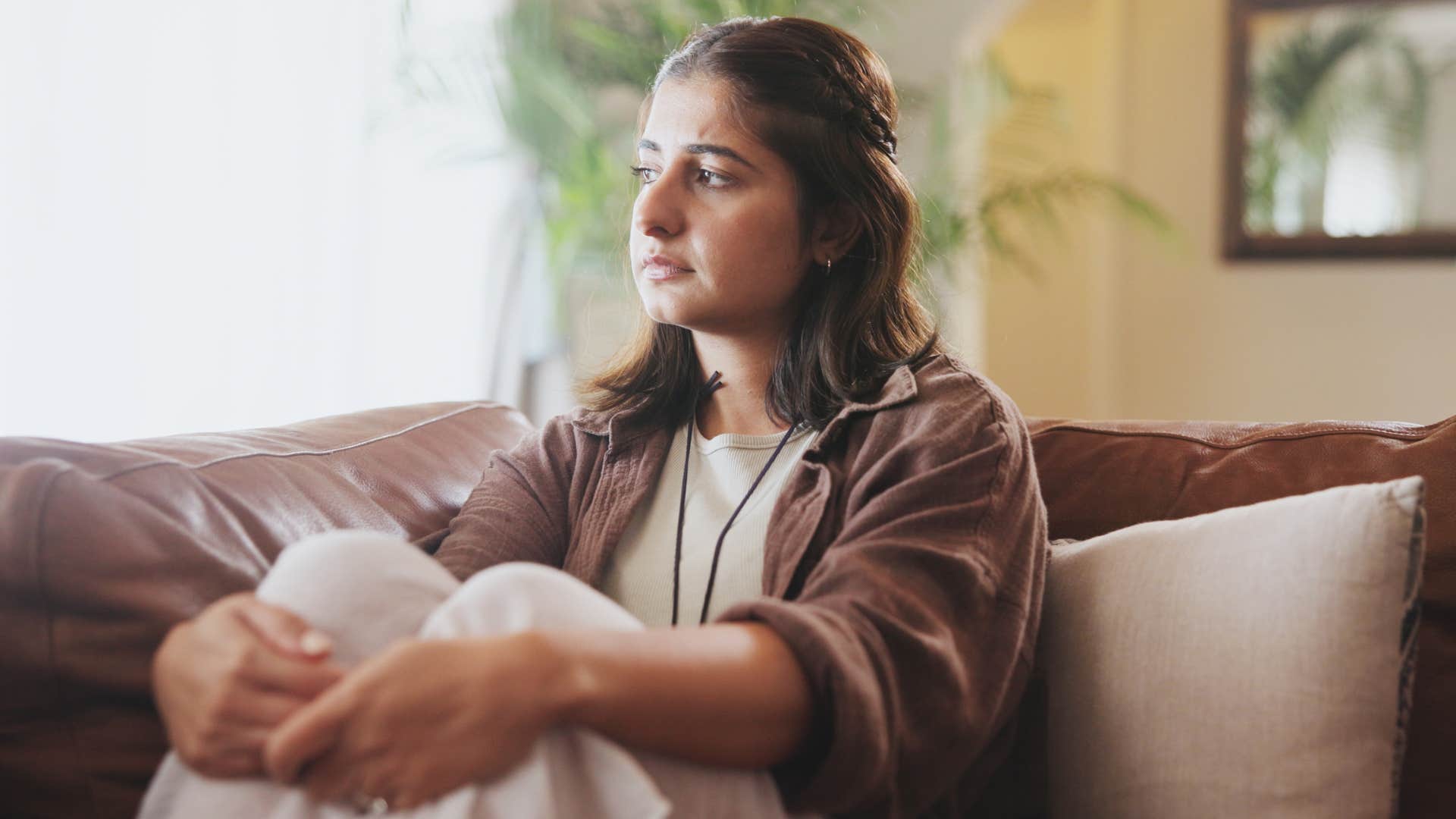 emotionally withdrawn woman sitting at home alone