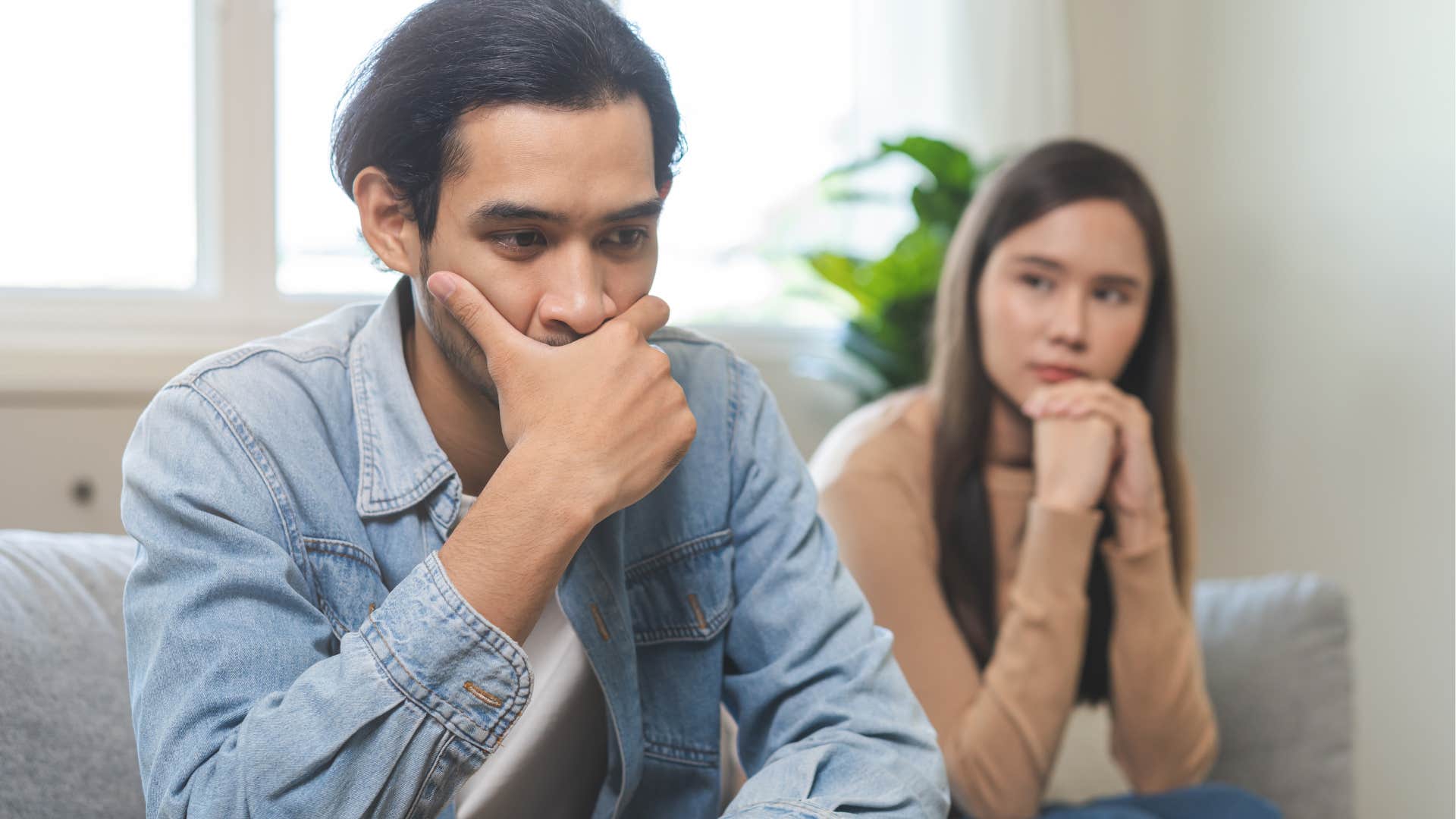 ashamed man avoiding conversations about relationship issues with his wife