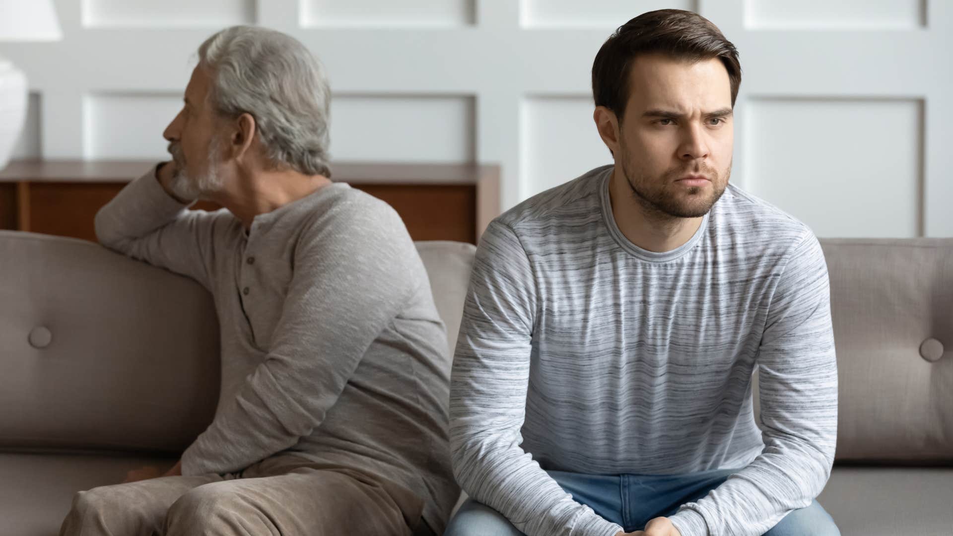Gen X parent turned away from his Gen Z son who looks annoyed