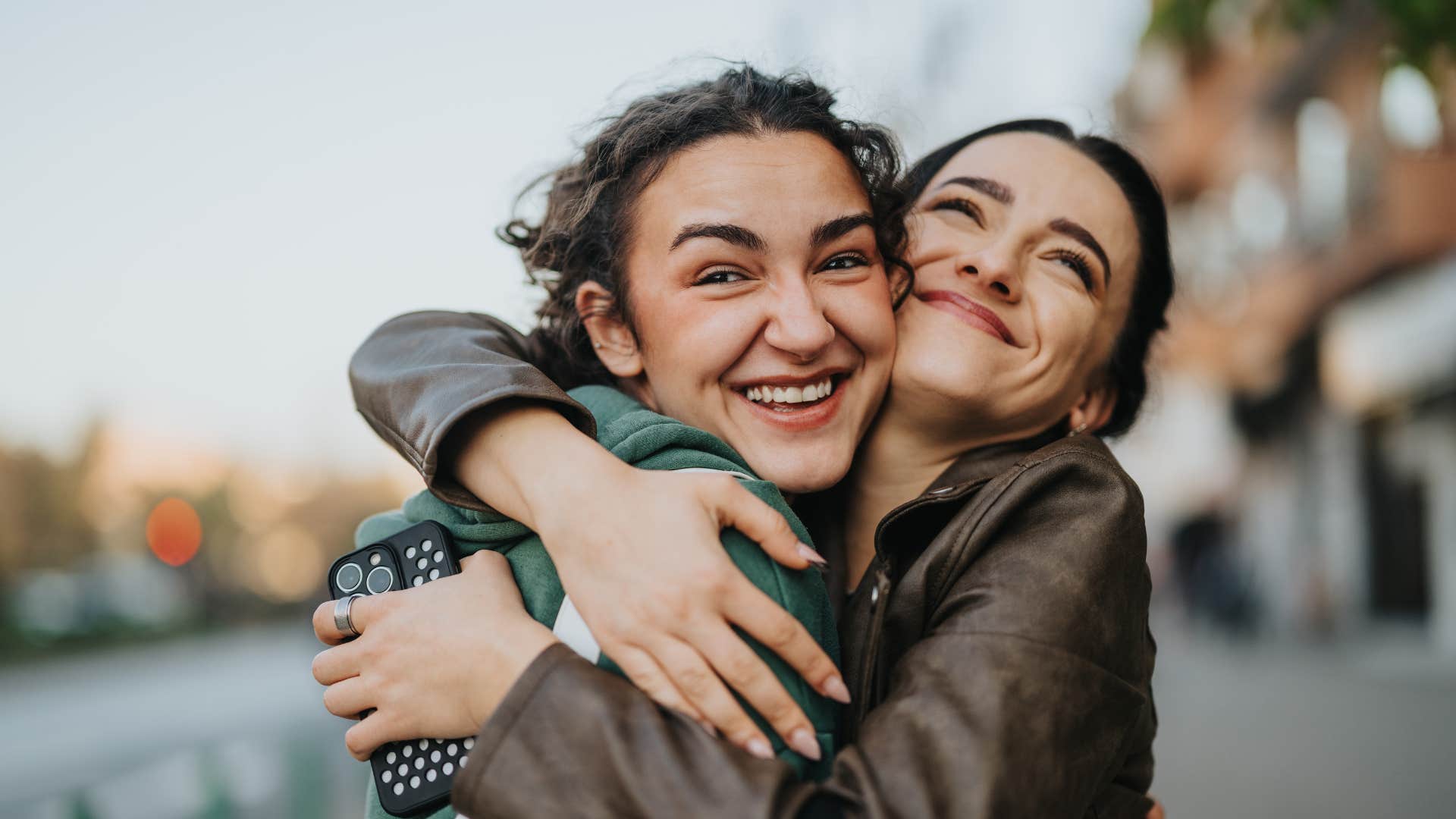grateful friends hugging tightly 