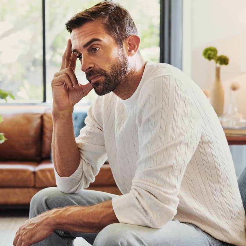 man listening to his phone ringing and not picking up