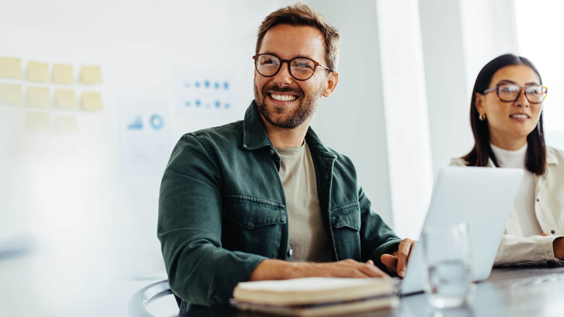 businessman asking colleague how they got so good at their skills in work meeting