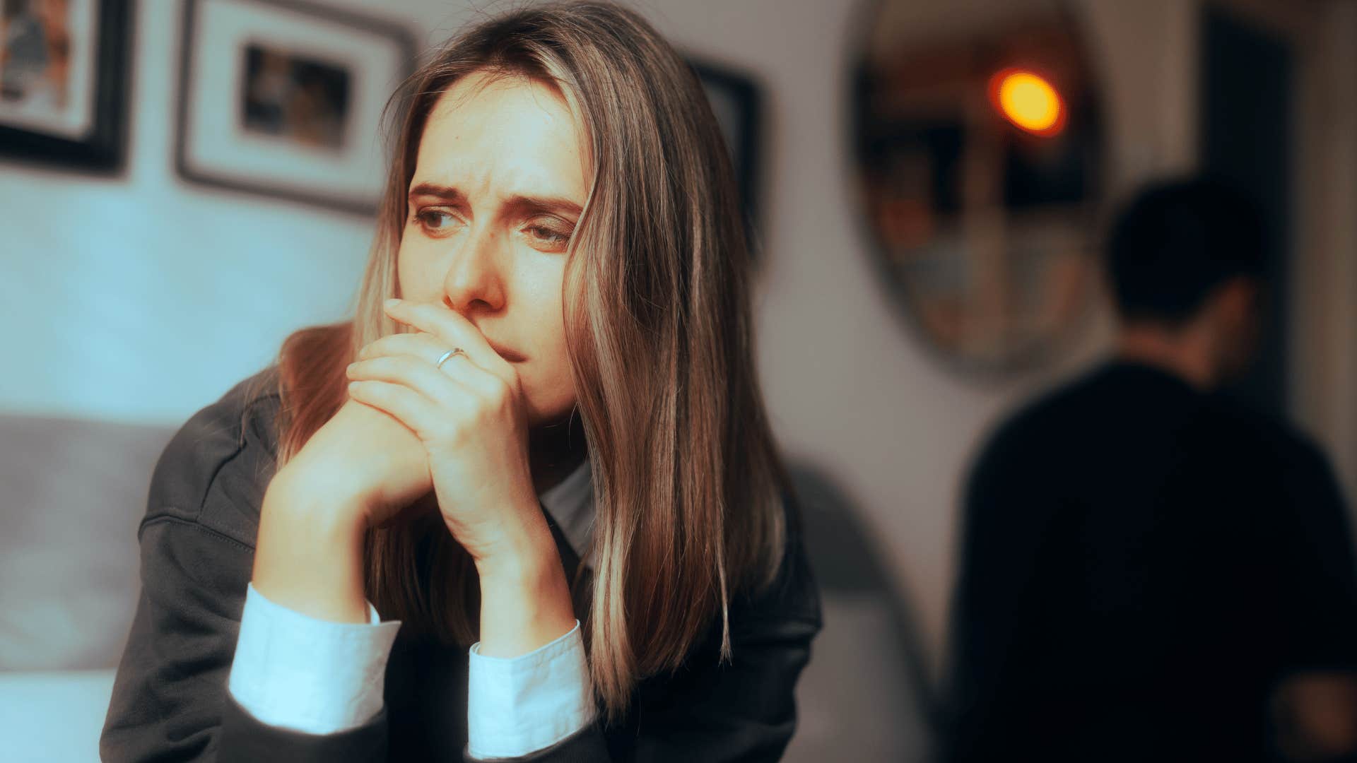Sad woman turned away from a controlling man 