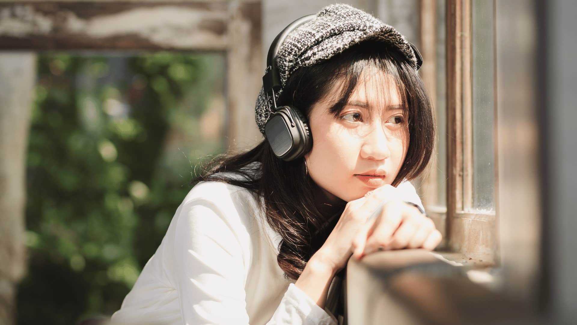 Woman with headphones worried about being lazy but she's overwhelmed