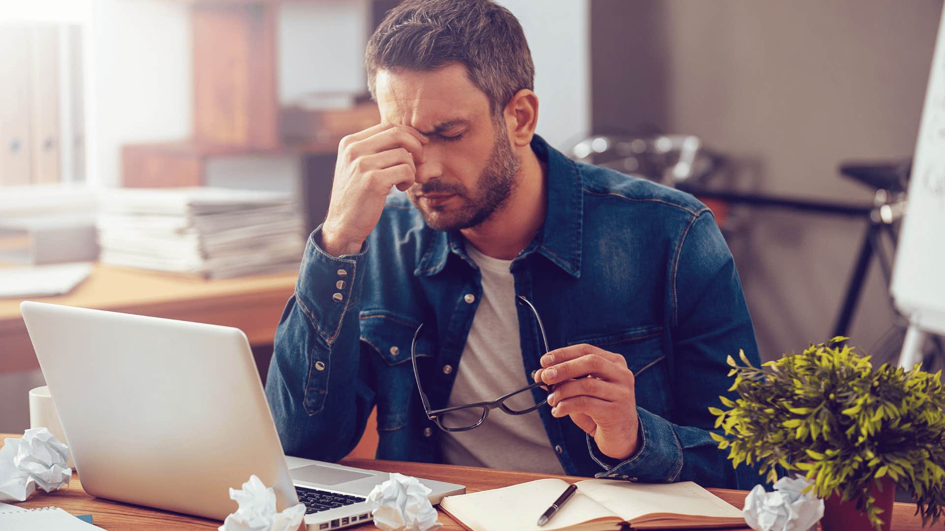 Man looking stressed at work isn't lazy he's overwhelmed 