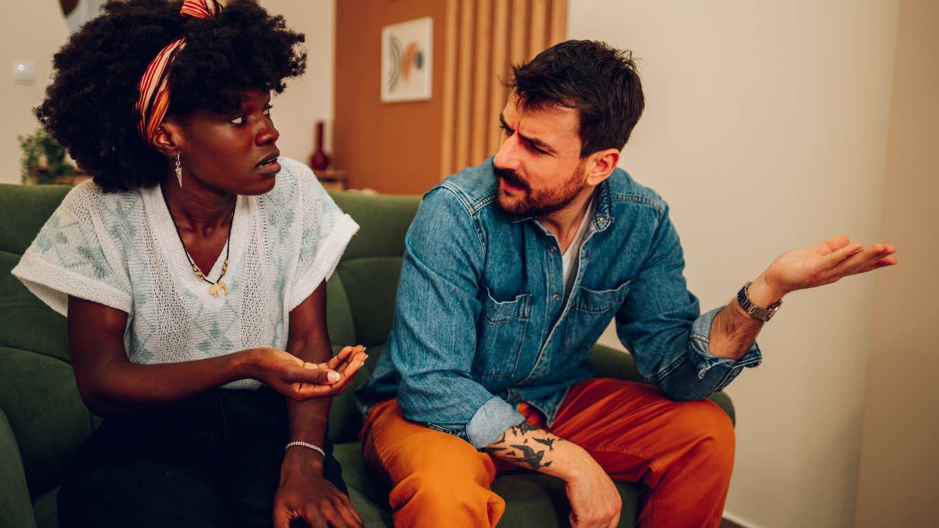 couple arguing on the couch man testing womans loyalty