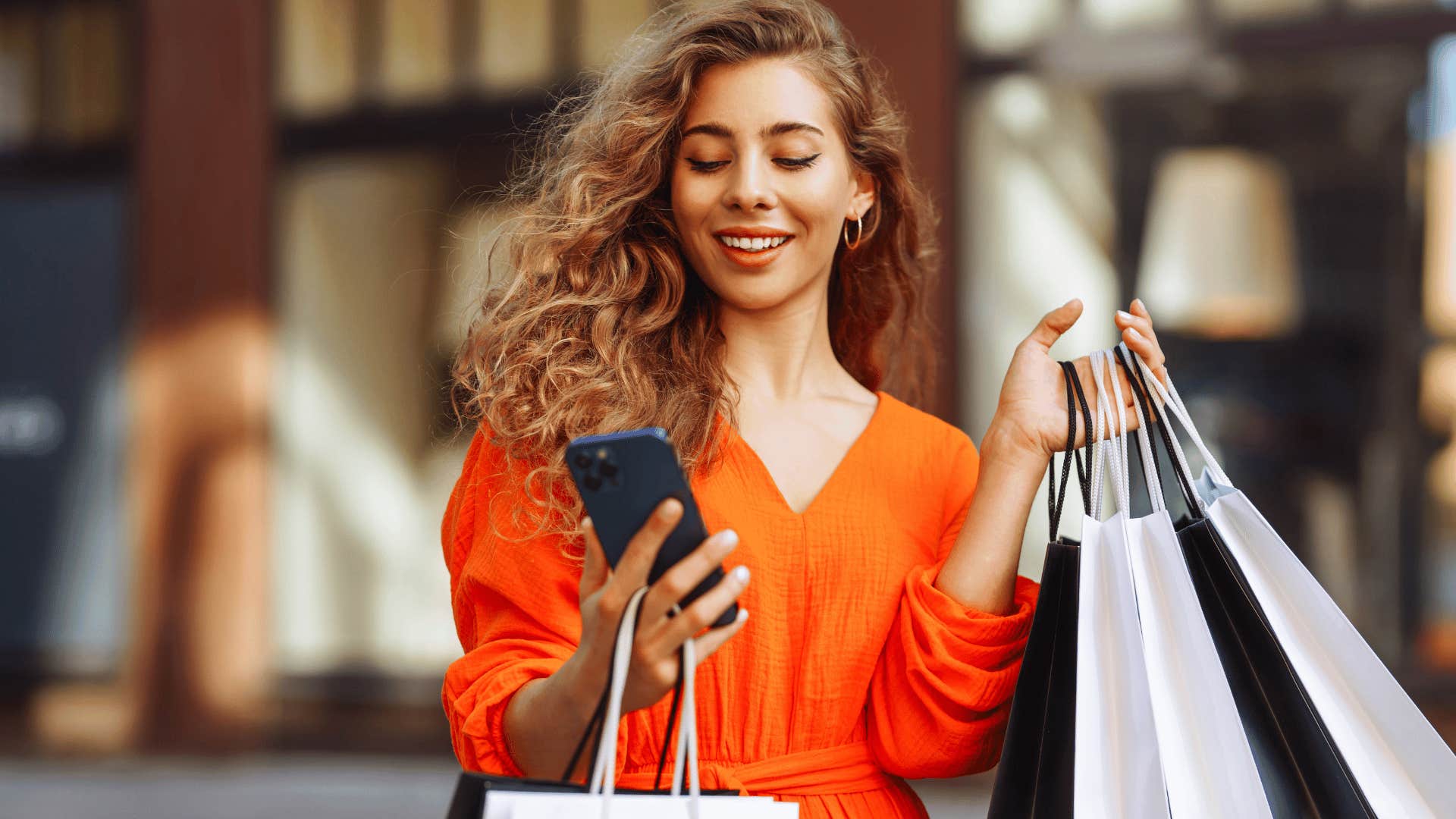 woman holding bags after going on shopping spree