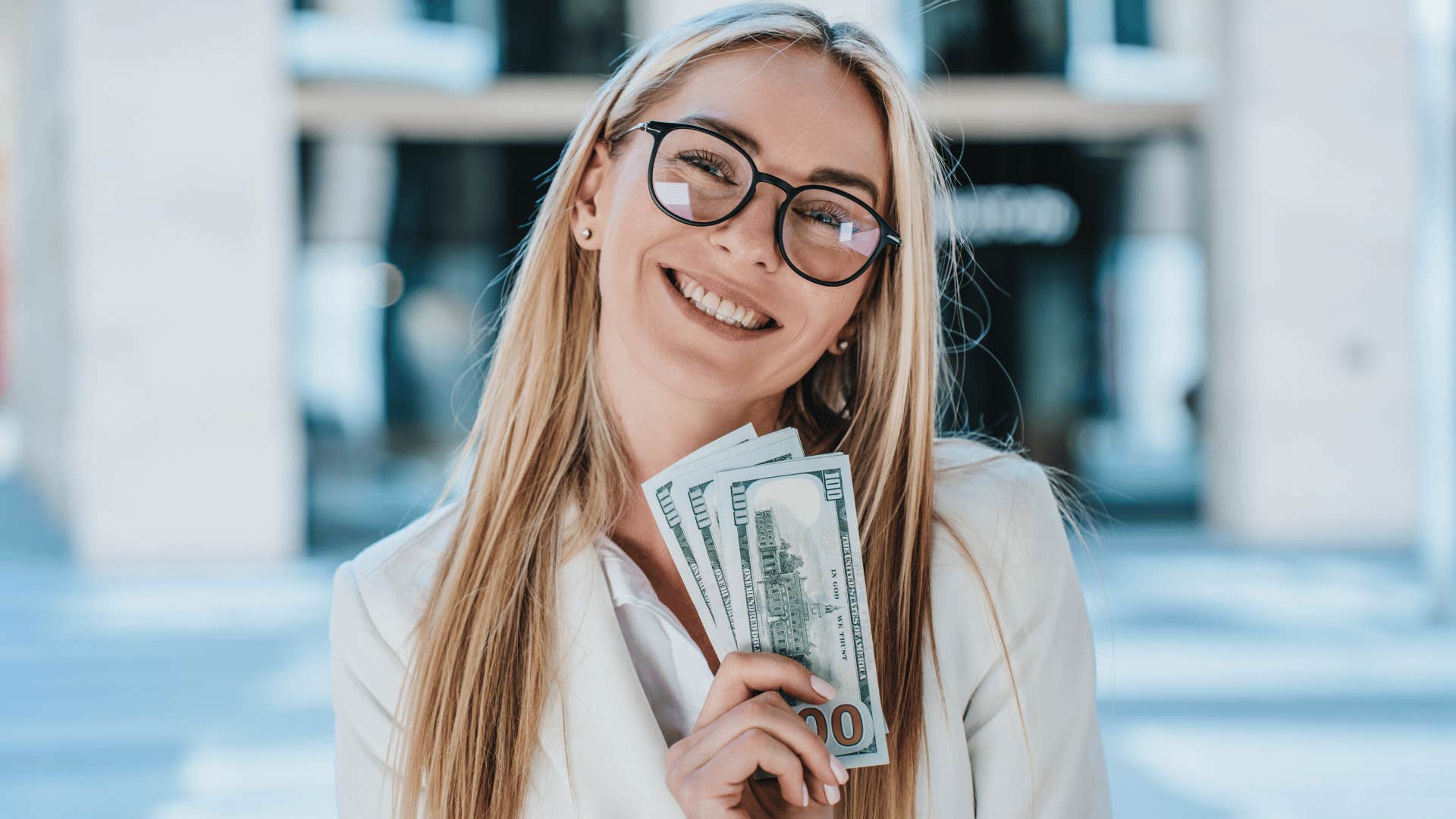 Woman holding up money that you probably shouldn't marry