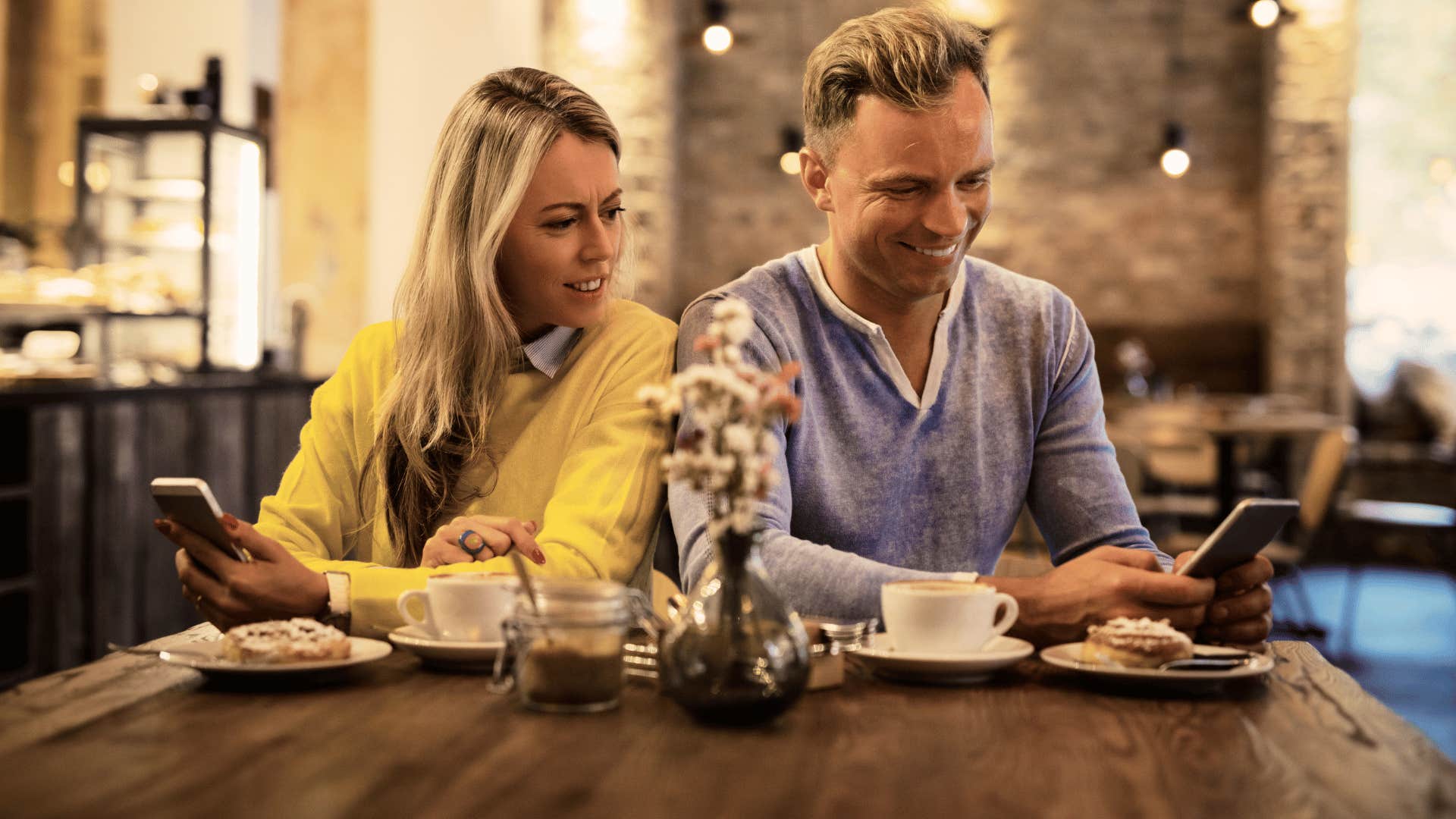 Man with a woman he probably shouldn't marry looking at his phone